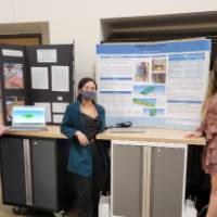 people standing next to a project